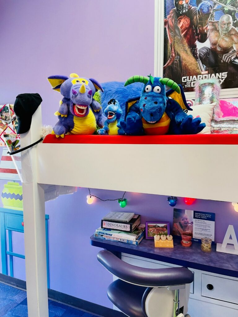 Friendly stuffed animals on a shelf in a dental office.