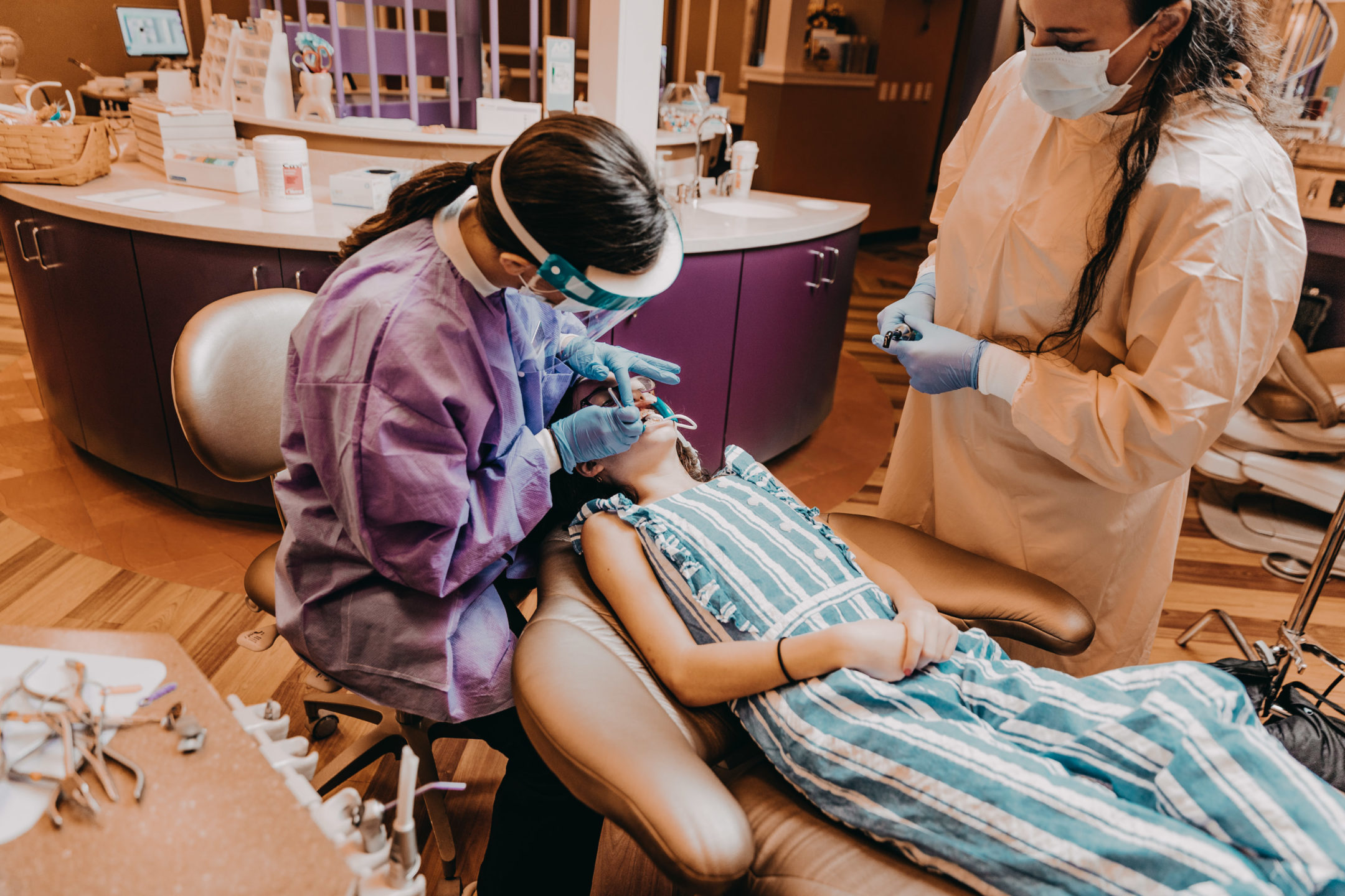 A young girl receives an orthodontic exam.