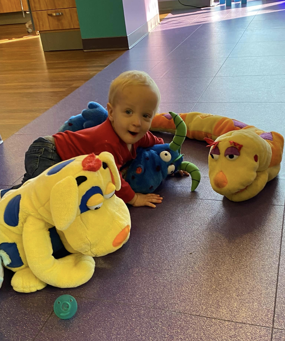A toddler enjoys playing with puppets at  Newtown Dentistry.