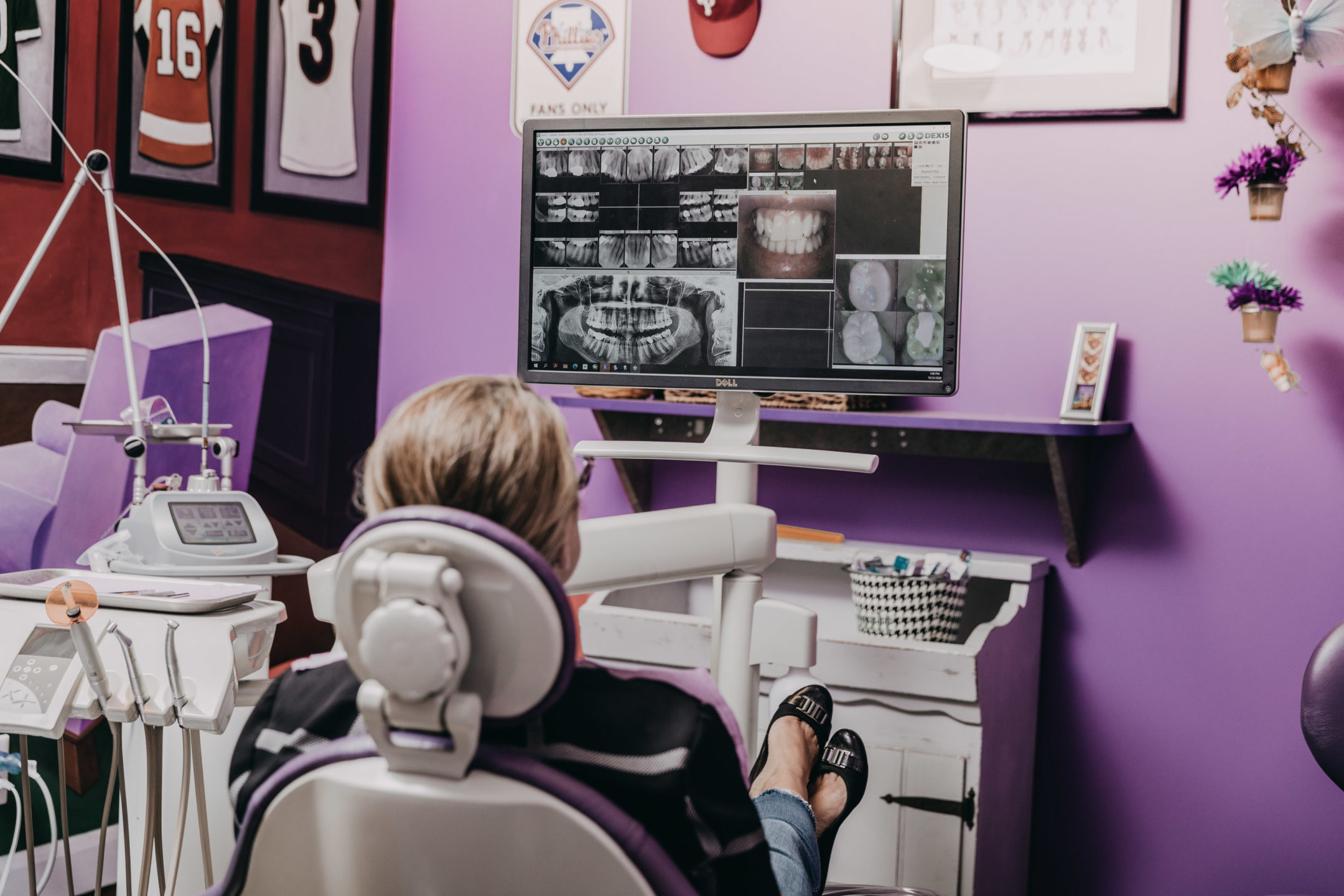 A patient looks at the 3D images of her teeth on a screen in the orthodontist’s office. 