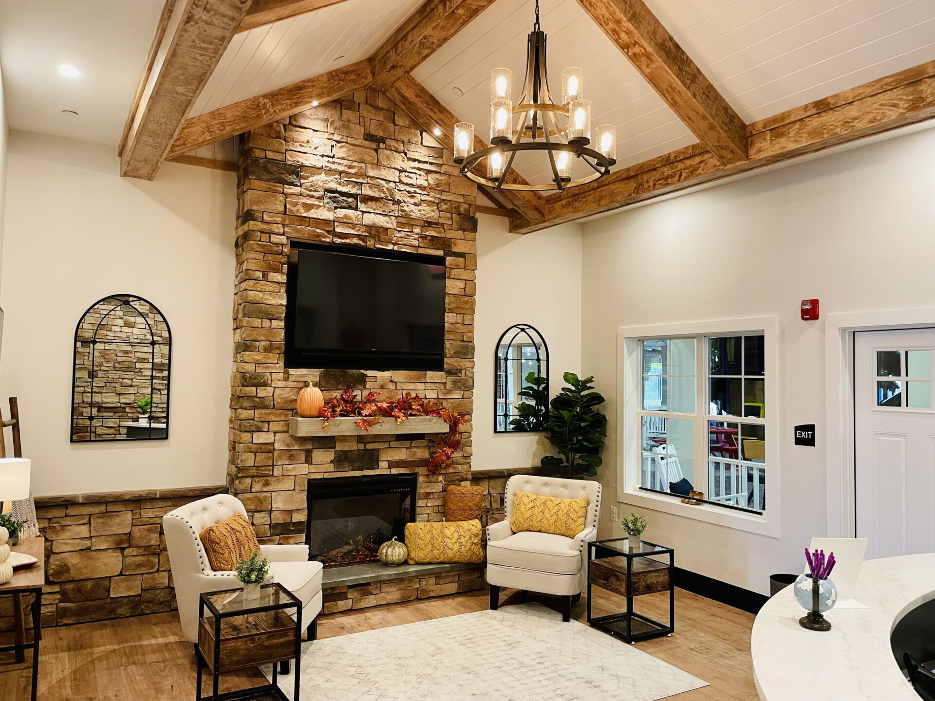 Image of dental office lobby with brick fireplace, sitting chairs, and white carpet. 