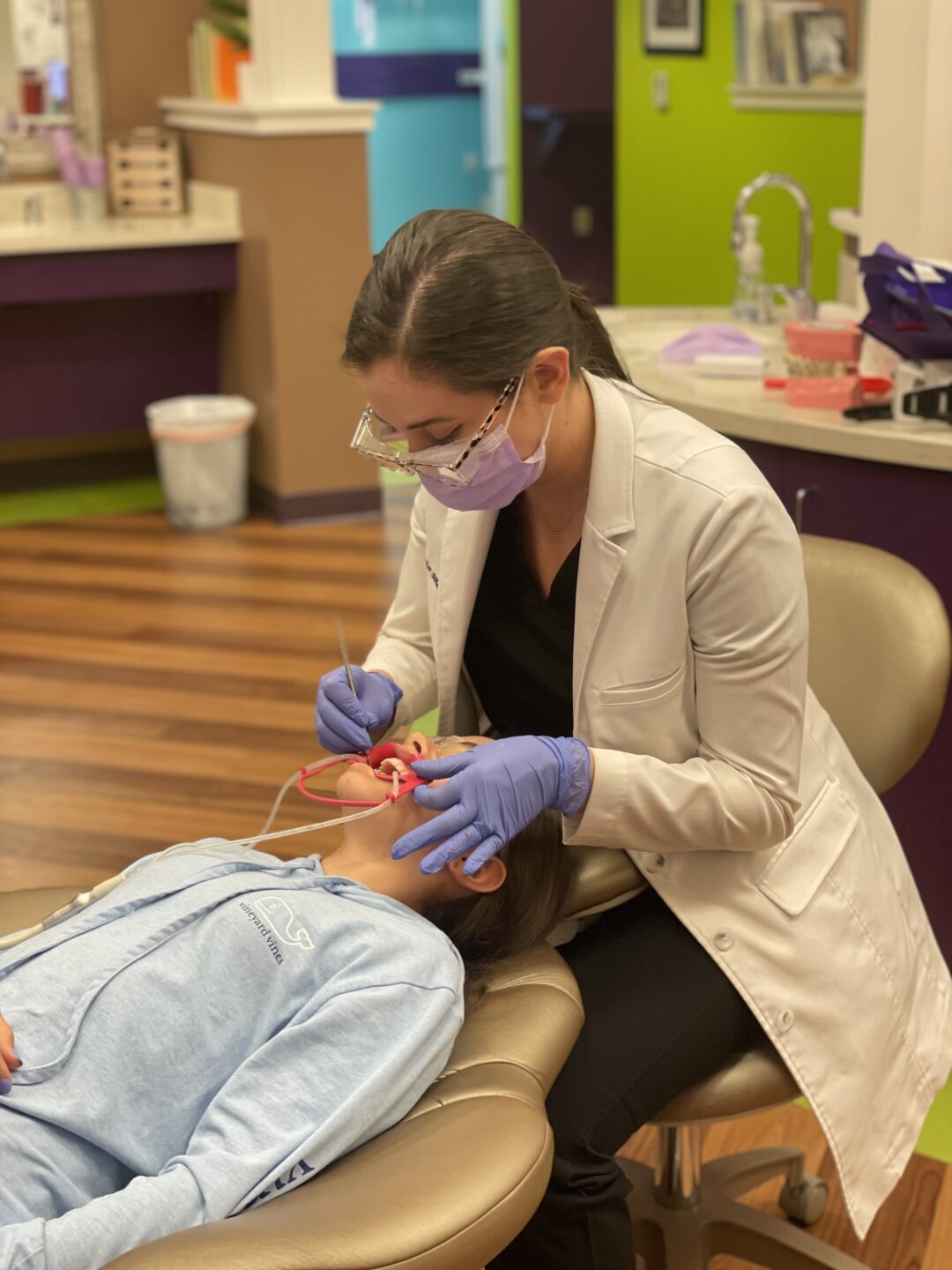  Young orthodontist patient in dental chair in office. 
