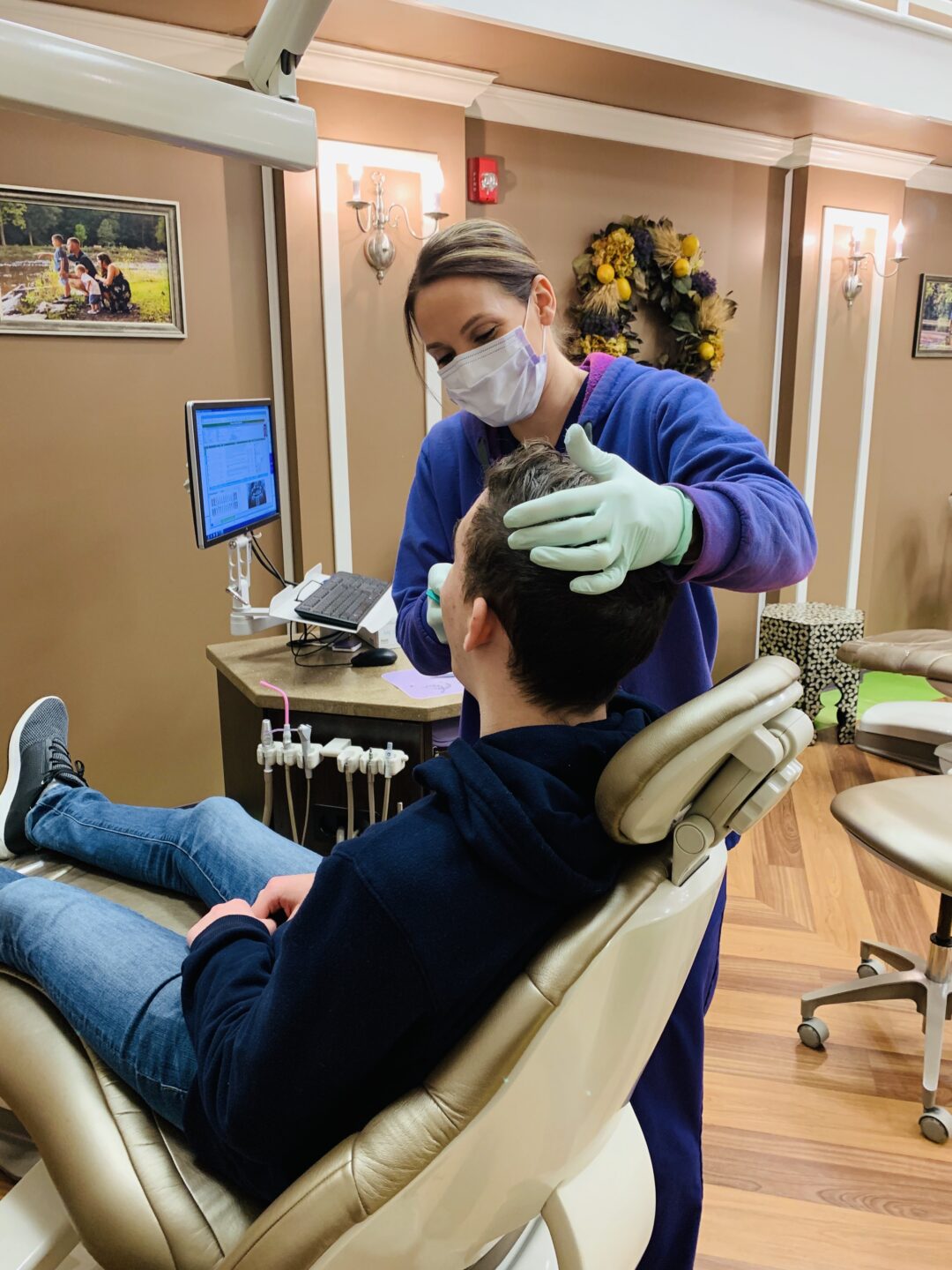  Dental patient being consulted by an orthodontist in the dentist’s office. 