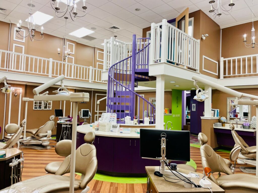  Image of the brightly lit orthodontic offices of Newtown Dentistry with purple spiral staircase in the center.