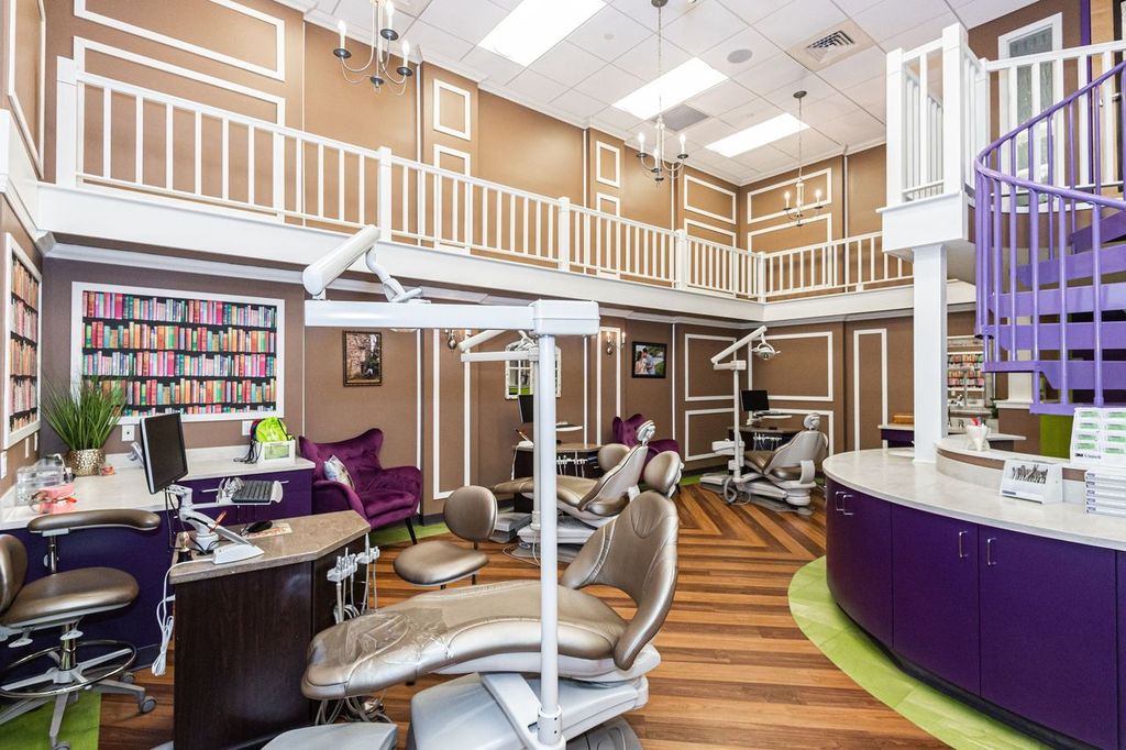 Image of an orthodontist’s office with spiral purple staircase in the center and several dental stations with patient chairs.